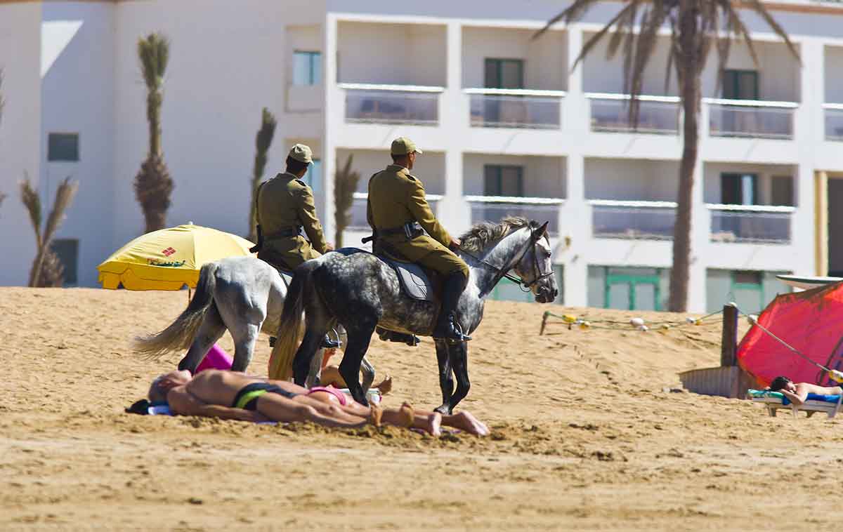 Policia a caballo por las playas de Marruecos